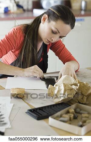 Young woman drawing with charcoal View Large Photo Image Stock Photograph - Young woman drawing with charcoal. Fotosearch