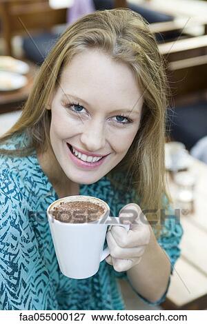 Young woman enjoying cup of cappuccino, portrait View Large Photo Image Stock Photo - Young woman enjoying cup of cappuccino, portrait. Fotosearch