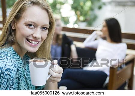 Young woman enjoying cup of coffee, portrait View Large Photo Image Stock Photograph - Young woman enjoying cup of coffee, portrait. Fotosearch