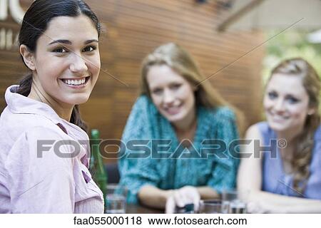 Young woman relaxing with friends View Large Photo Image Stock Photo - Young woman relaxing with friends. Fotosearch