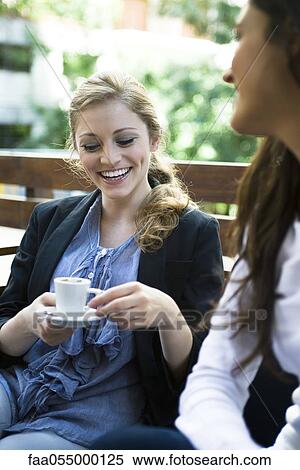 Young woman with friend at cafe View Large Photo Image Stock Photography - Young woman with friend at cafe. Fotosearch