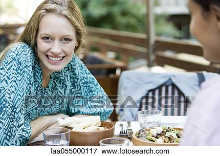 Young woman with friend at restaurant View Large Photo Image Stock Photo - Young woman with friend at restaurant. Fotosearch