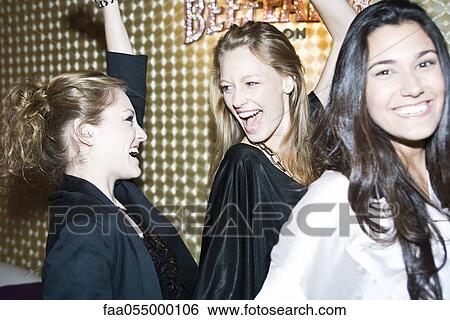 Young women dancing in night club View Large Photo Image Stock Photograph - Young women dancing in night club. Fotosearch