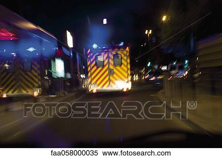 Ambulance driving on street at night View Large Photo Image Stock Photography - Ambulance driving on street at night. Fotosearch
