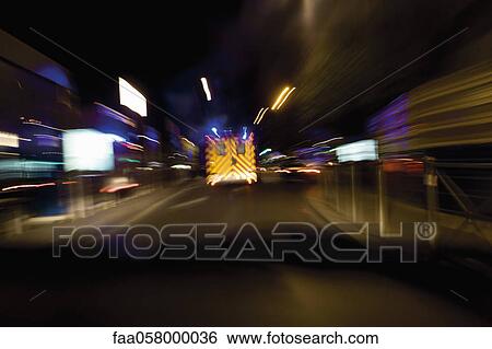 Ambulance rushing down street at night View Large Photo Image Stock Photograph - Ambulance rushing down street at night. Fotosearch