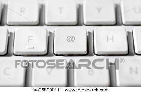 Stock Image - At sign on laptop computer keyboard. Fotosearch