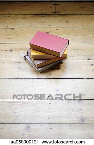 Books stacked on hardwood floor View Large Photo Image Stock Image - Books stacked on hardwood floor. Fotosearch