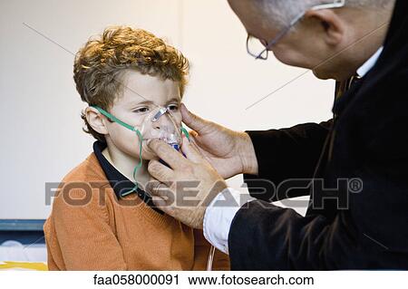 Boy receiving oxygen treatment View Large Photo Image Stock Image - Boy receiving oxygen treatment. Fotosearch