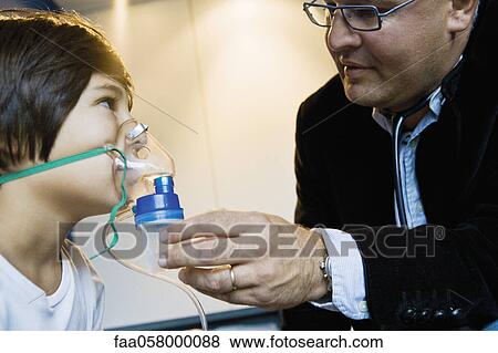 Boy receiving oxygen treatment View Large Photo Image Stock Photo - Boy receiving oxygen treatment. Fotosearch