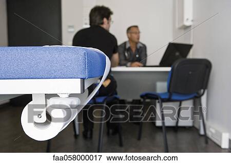 Doctor consulting patient in clinic View Large Photo Image Stock Photo - Doctor consulting patient in clinic. Fotosearch