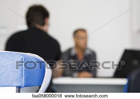 Doctor consulting patient in clinic View Large Photo Image Stock Photo - Doctor consulting patient in clinic. Fotosearch