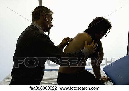 Doctor listening to patient's back with stethoscope View Large Photo Image Stock Image - Doctor listening to patient's back with stethoscope. Fotosearch