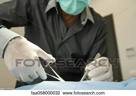 Doctor performing surgery View Large Photo Image Stock Image - Doctor performing surgery. Fotosearch