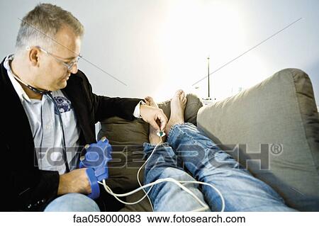 Doctor placing electrodes on patient in prepration for an EKG (electrocardiogram) View Large Photo Image Stock Image - Doctor placing electrodes on patient in prepration for an EKG (electrocardiogram). Fotosearch