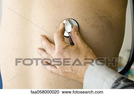 Doctor placing stethoscope on patient's back View Large Photo Image Stock Image - Doctor placing stethoscope on patient's back. Fotosearch