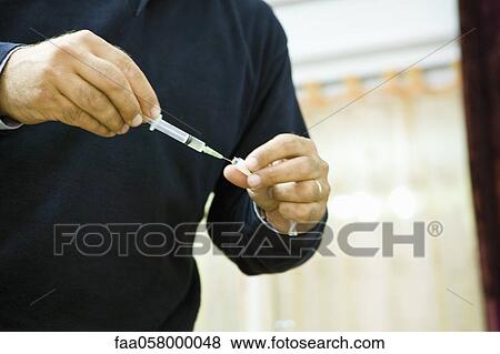 Doctor preparing an injection View Large Photo Image Stock Photo - Doctor preparing an injection. Fotosearch