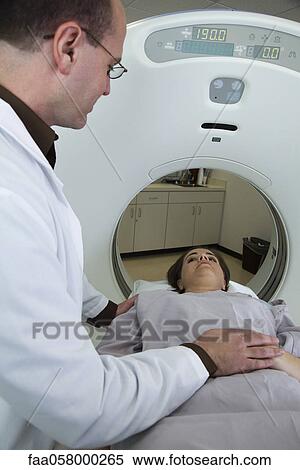 Doctor reassuring female patient preparing to undergo CAT scan View Large Photo Image Stock Photography - Doctor reassuring female patient preparing to undergo CAT scan. Fotosearch