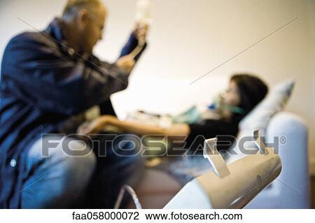 Doctor treating patient in home View Large Photo Image Stock Image - Doctor treating patient in home. Fotosearch