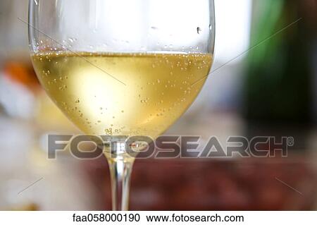 Droplets of condensation on glass of chilled white wine View Large Photo Image Stock Image - Droplets of condensation on glass of chilled white wine. Fotosearch