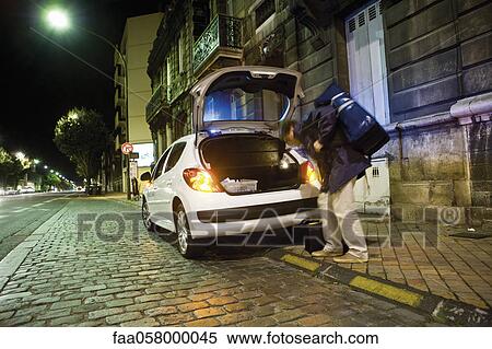 Stock Photography - Emergency on-call doctor making a house call at night. Fotosearch