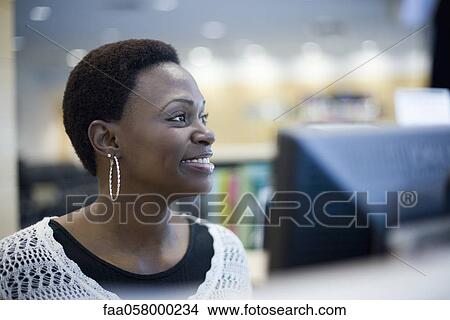 Female office worker looking away smiling View Large Photo Image Picture - Female office worker looking away smiling. Fotosearch
