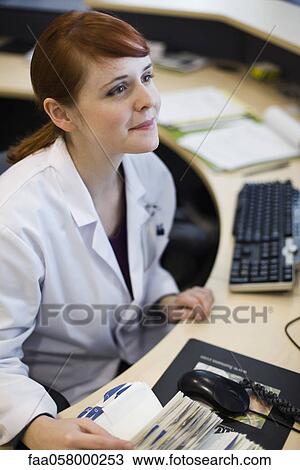 Female receptionist in health care center View Large Photo Image Stock Image - Female receptionist in health care center. Fotosearch