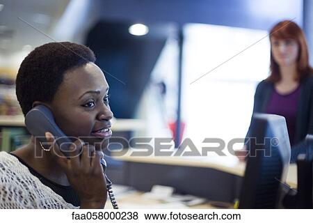 Female receptionist talking on phone View Large Photo Image Stock Photo - Female receptionist talking on phone. Fotosearch