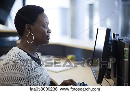 Female receptionist typing View Large Photo Image Stock Photograph - Female receptionist typing. Fotosearch