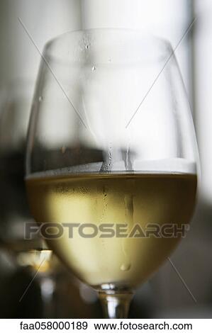 Glass of chilled white wine View Large Photo Image Stock Photo - Glass of chilled white wine. Fotosearch