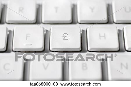 Stock Photo - Great Britain Pound symbol on laptop computer keyboard. Fotosearch