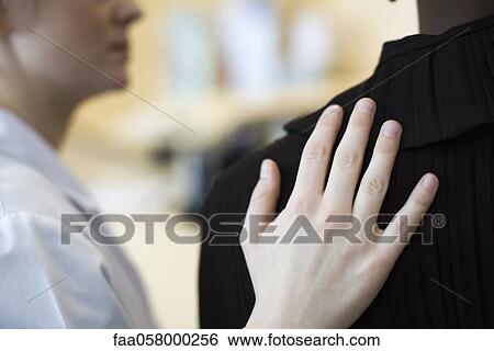 Hand on shoulder, close-up View Large Photo Image Stock Photograph - Hand on shoulder, close-up. Fotosearch