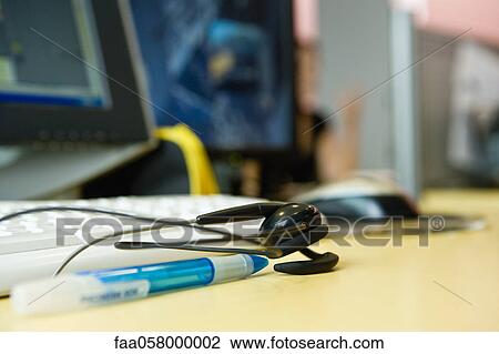 Headset resting on desk View Large Photo Image Stock Image - Headset resting on desk. Fotosearch
