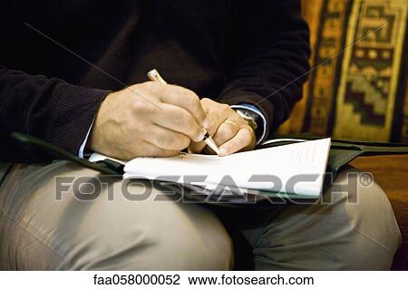 Man writing on note pad, cropped View Large Photo Image Stock Image - Man writing on note pad, cropped. Fotosearch