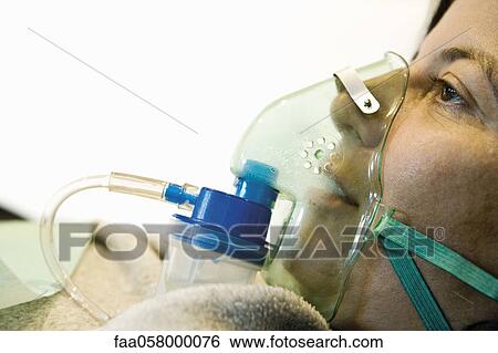 Patient wearing oxygen mask, close-up View Large Photo Image Stock Photograph - Patient wearing oxygen mask, close-up. Fotosearch