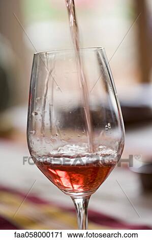 Pouring glass of rose wine View Large Photo Image Stock Image - Pouring glass of rose wine. Fotosearch