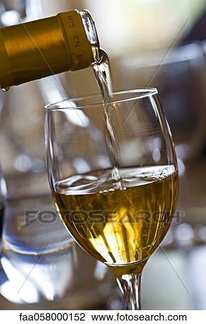 Pouring glass of white wine View Large Photo Image Stock Image - Pouring glass of white wine. Fotosearch