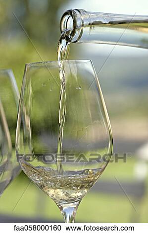 Pouring glass of white wine View Large Photo Image Stock Image - Pouring glass of white wine. Fotosearch