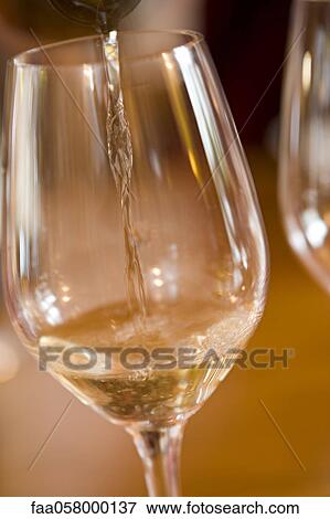 Pouring glass of white wine View Large Photo Image Stock Photo - Pouring glass of white wine. Fotosearch