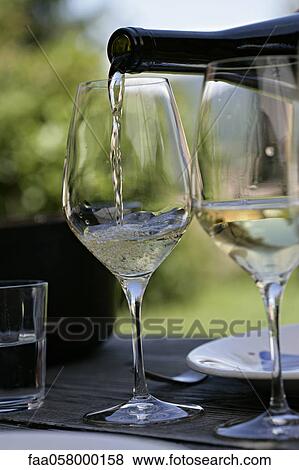 Pouring glass of white wine View Large Photo Image Stock Photo - Pouring glass of white wine. Fotosearch