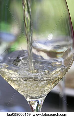 Pouring glass of white wine View Large Photo Image Stock Photo - Pouring glass of white wine. Fotosearch