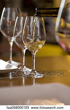 Pouring glasses of white wine View Large Photo Image Stock Image - Pouring glasses of white wine. Fotosearch