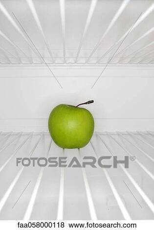 Stock Photo - Single green apple sitting on shelf inside refrigerator. Fotosearch