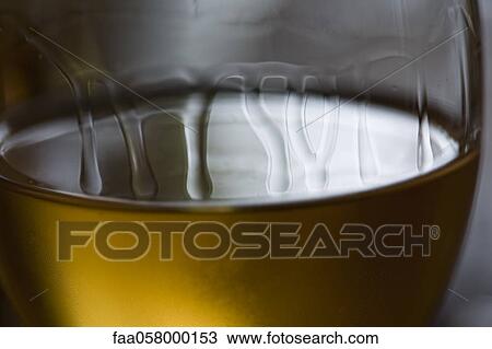 Tears of wine on glass of white wine View Large Photo Image Stock Image - Tears of wine on glass of white wine. Fotosearch