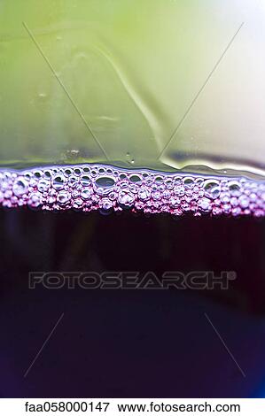 Stock Photo - Tiny bubbles on surface of red wine. Fotosearch