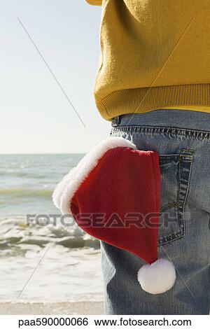 At beach looking at the view, Santa hat in back pocket View Large Photo Image Stock Photograph - At beach looking at the view, Santa hat in back pocket. Fotosearch