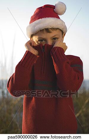 Boy covering face with sweater collar View Large Photo Image Stock Photograph - Boy covering face with sweater collar. Fotosearch