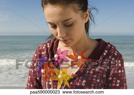 Preteen girl with pinwheels, portrait View Large Photo Image Stock Image - Preteen girl with pinwheels, portrait. Fotosearch