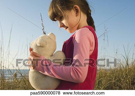 Young girl holding stuffed toy polar bear cub View Large Photo Image Stock Photo - Young girl holding stuffed toy polar bear cub. Fotosearch