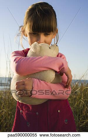 Young girl hugging stuffed toy polar bear cub View Large Photo Image Stock Photography - Young girl hugging stuffed toy polar bear cub. Fotosearch