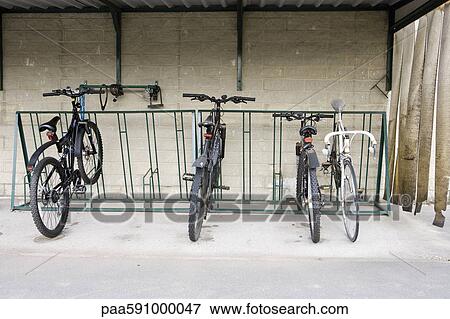 Bicycles parked in sheltered bicycle rack View Large Photo Image Stock Photo - Bicycles parked in sheltered bicycle rack. Fotosearch